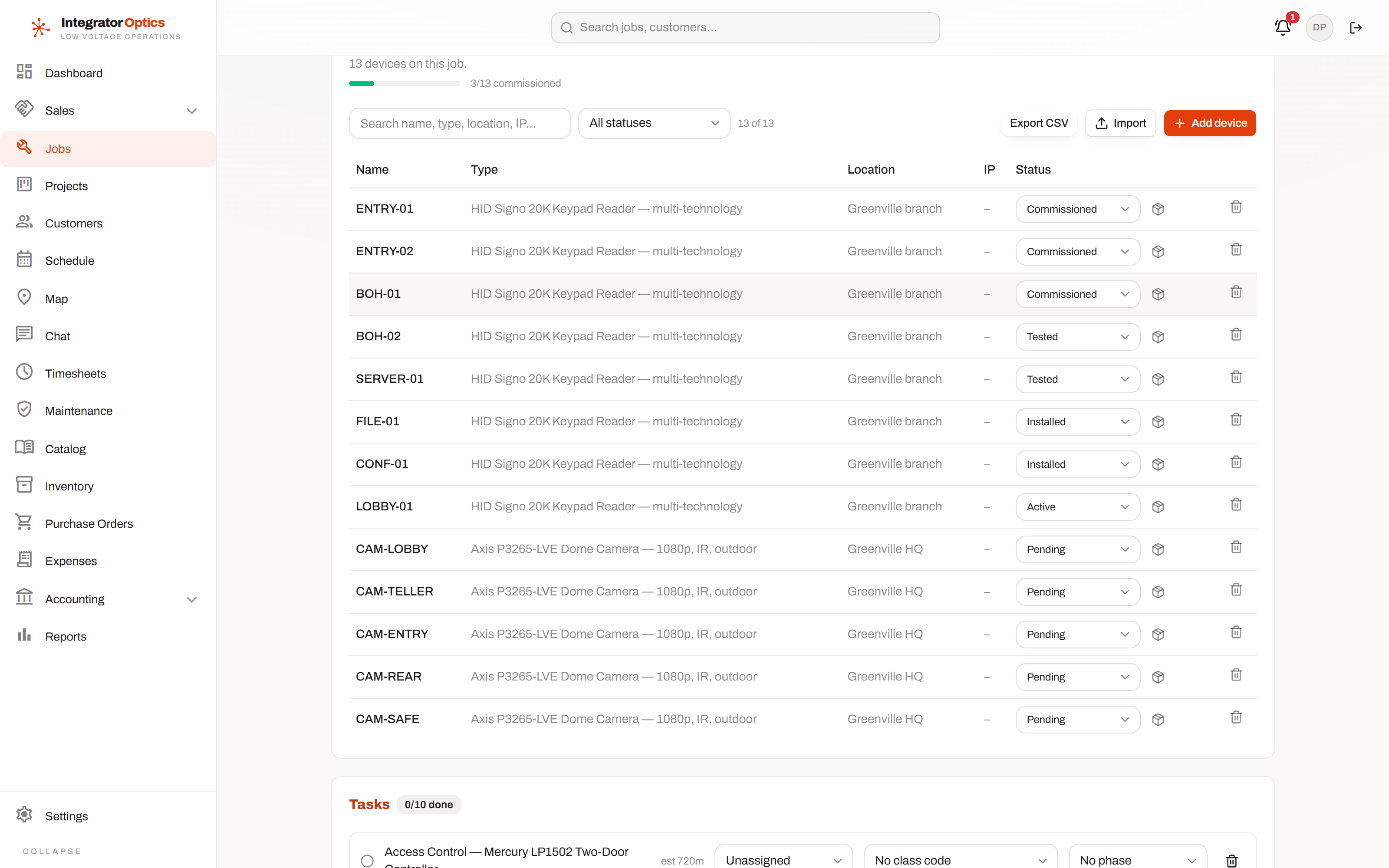 The device register on a job: thirteen devices with names, types, locations and individual commissioning statuses, and commissioning tasks beneath